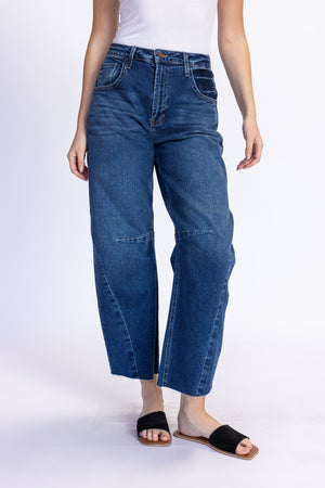 Person wearing blue jeans on a white background