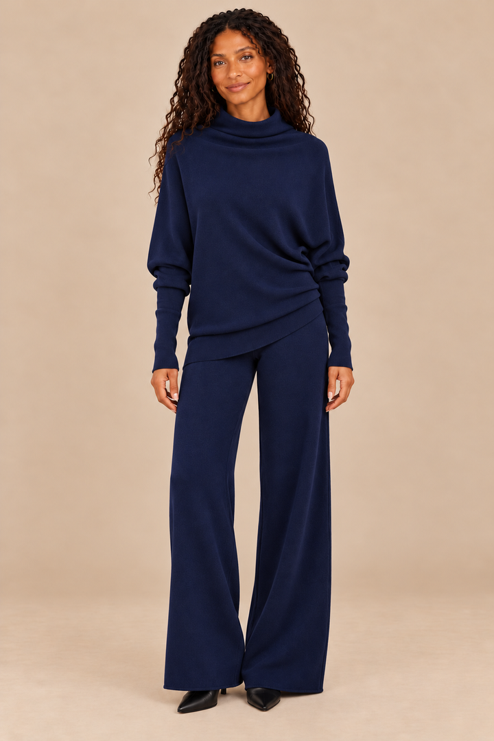 Cassie Navy asymmetrical drape sweater high-drape on campaign model with navy pants