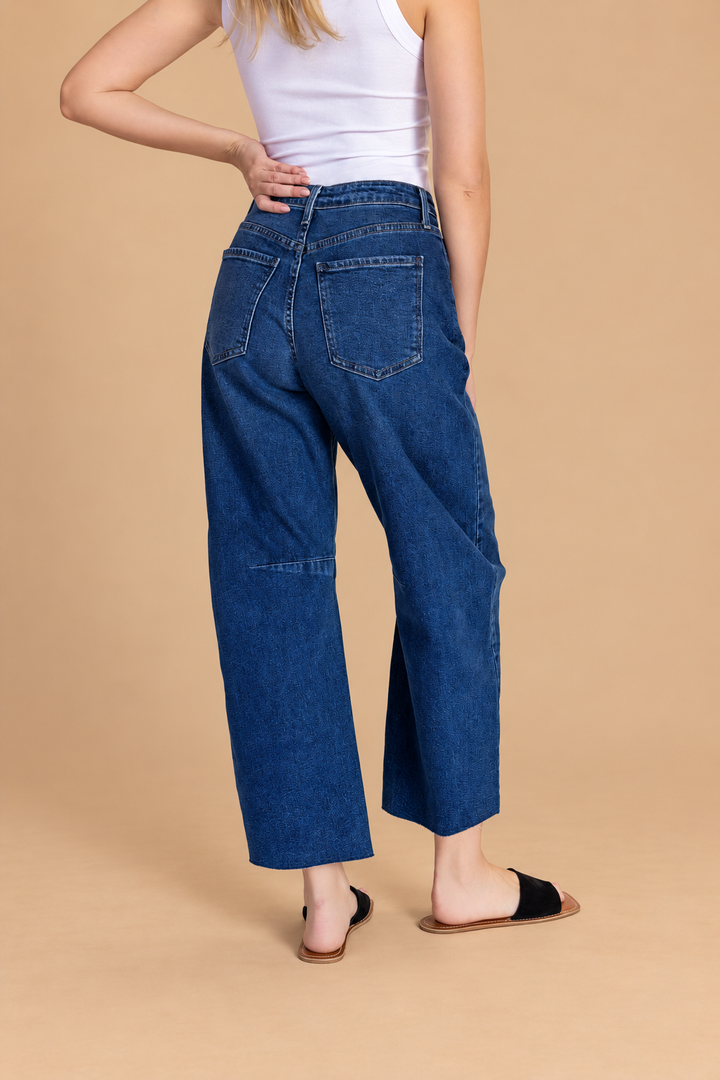 Barrel Jean — Dark Denim, back view on tan background