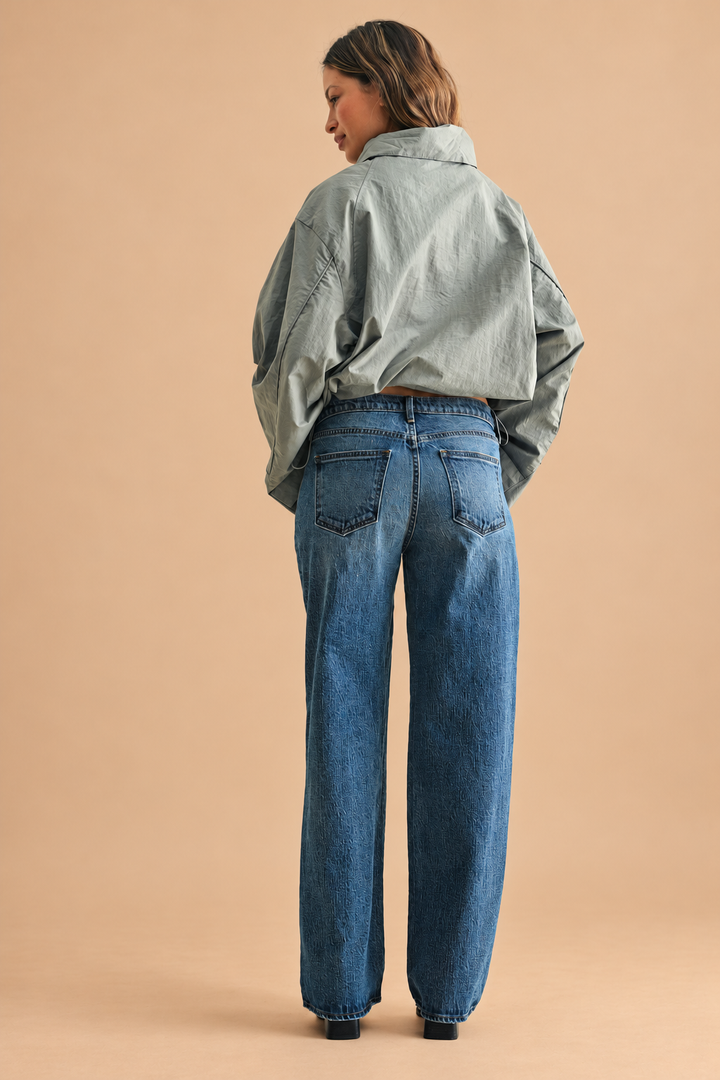 Lightweight Relaxed Straight Jean — Dark Denim, back view on tan background