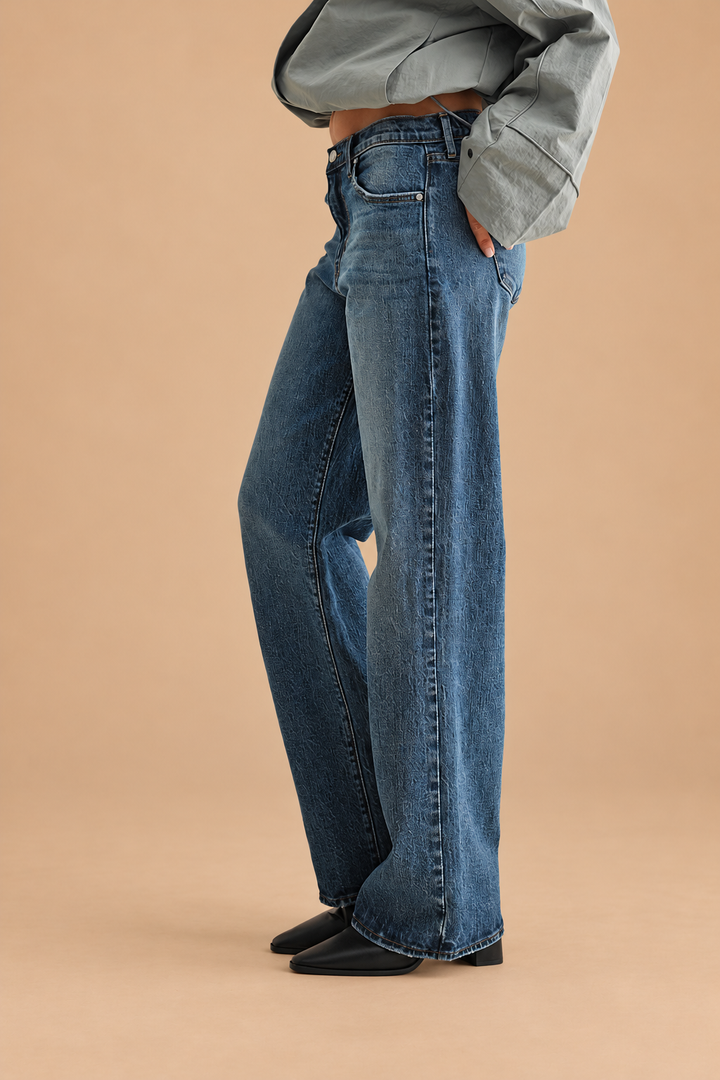 Lightweight Relaxed Straight Jean — Dark Denim, side view on tan background