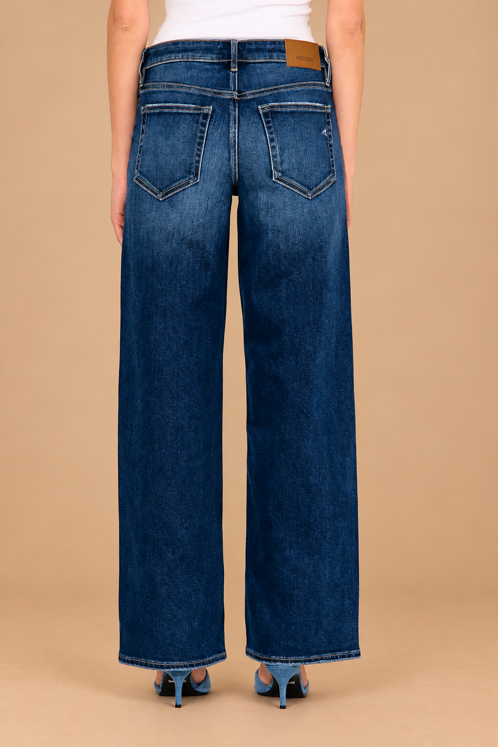 Logan Relaxed Jean — Dark, back view on tan background
