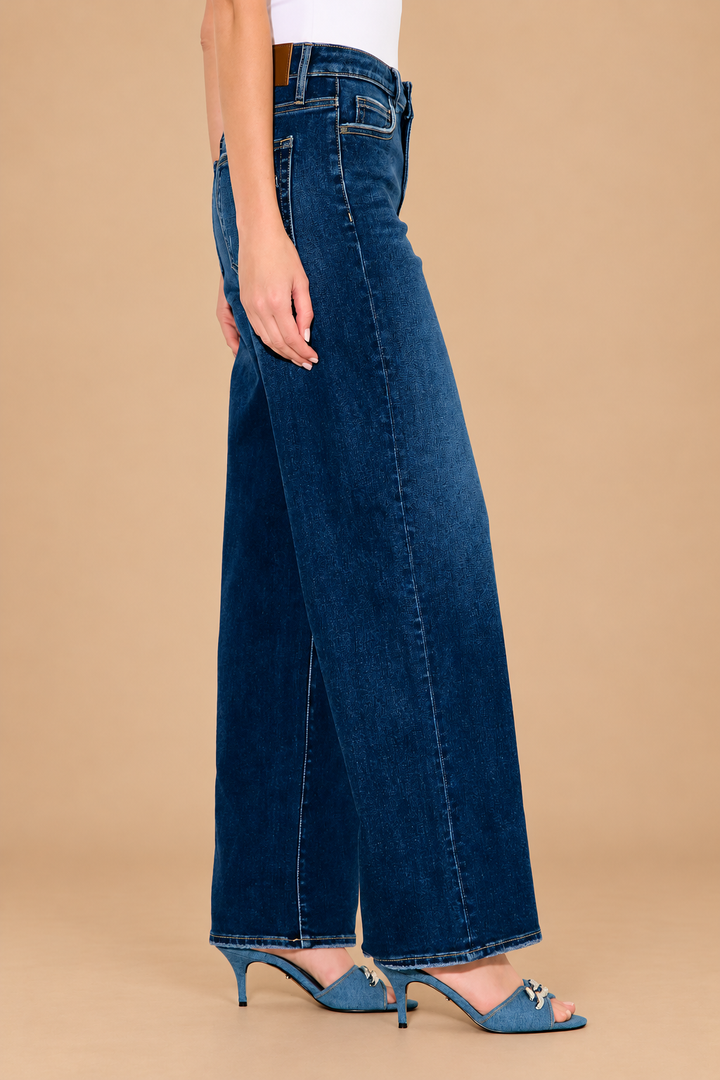 Logan Relaxed Jean — Dark, side view on tan background