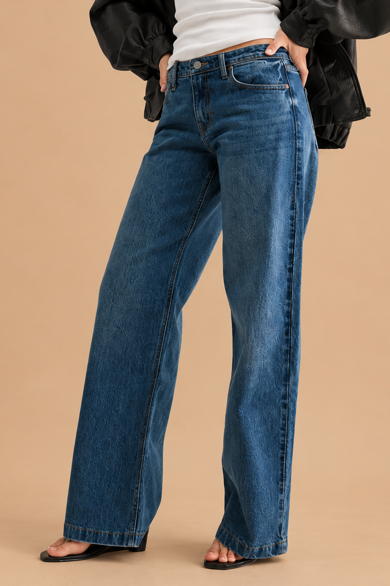 Low Rise Baggy Jean — Dark Denim, angled view on tan background