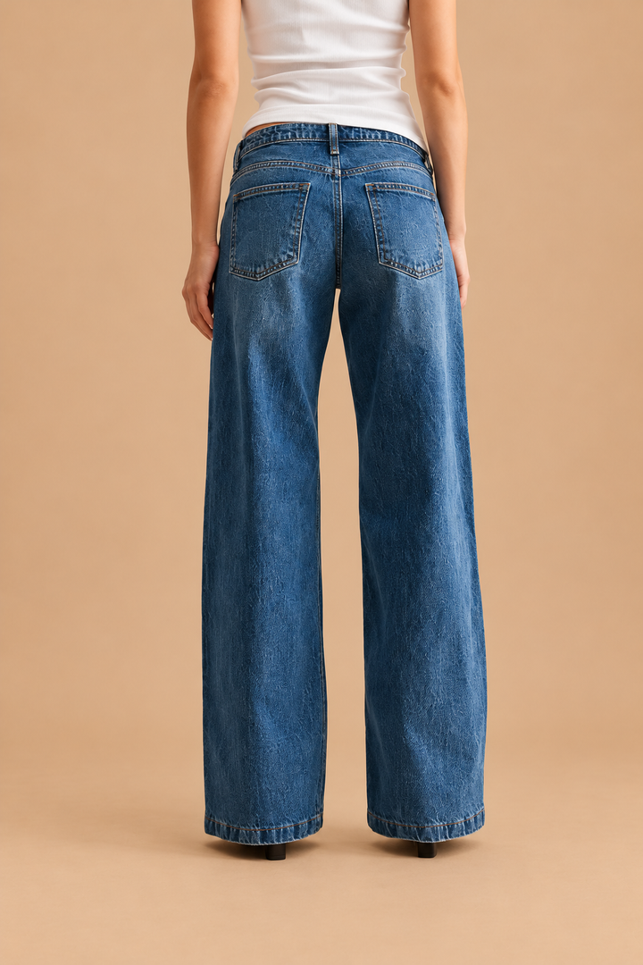 Low Rise Baggy Jean — Dark Denim, back view on tan background
