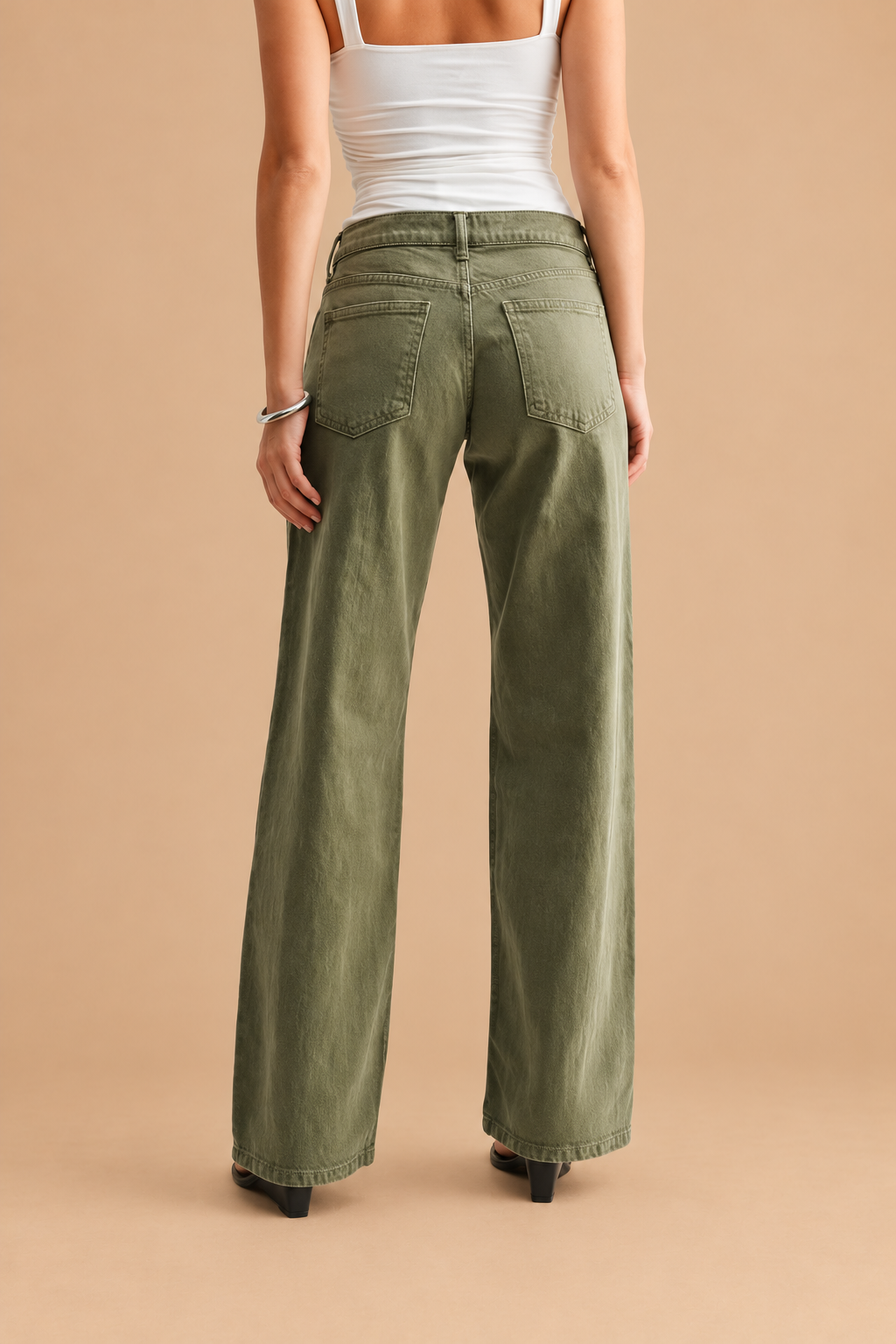 Low Rise Relaxed Straight Leg Jean — Dark Olive, back view on tan background