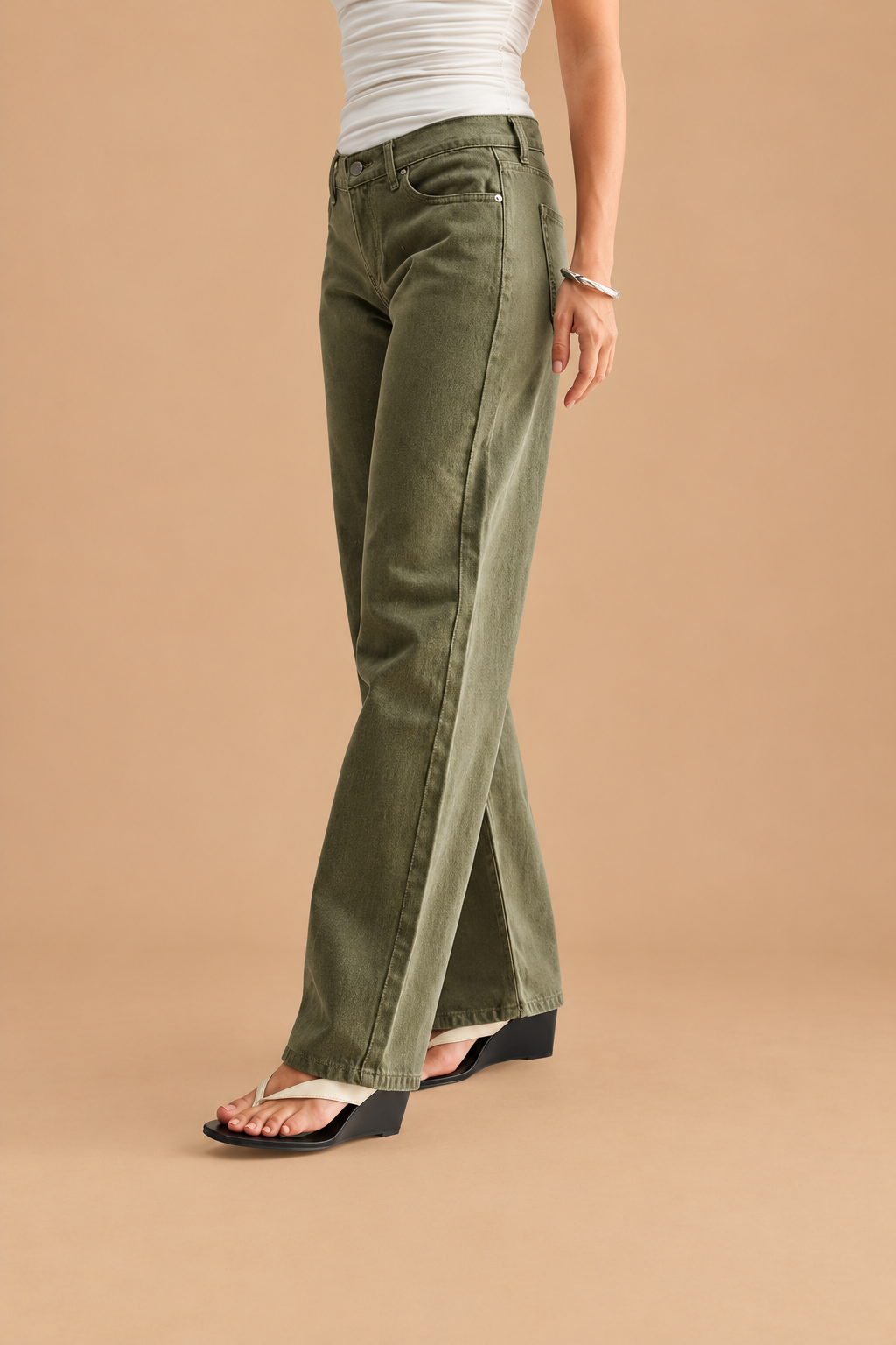 Low Rise Relaxed Straight Leg Jean — Dark Olive, side view on tan background