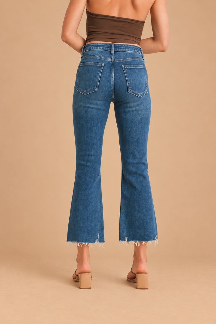 Marnie Cropped Flare Jean — Dark Denim, back view on tan background