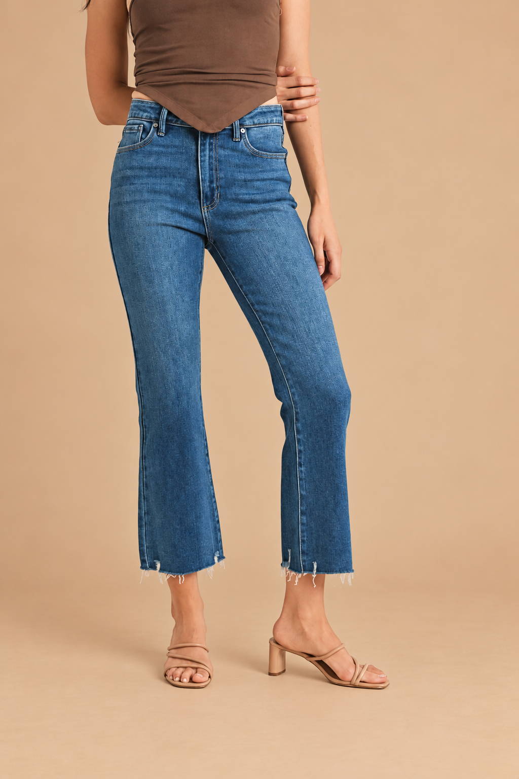 Marnie Cropped Flare Jean — Dark Denim, front view on tan background