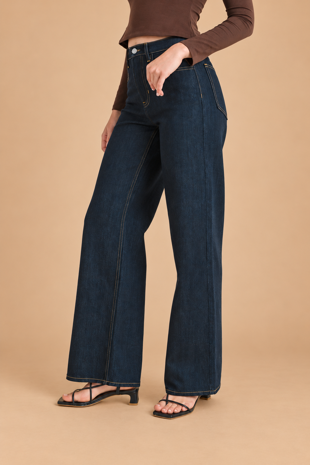 Relaxed Wide Straight Jean — Dark Denim, angled view on tan background