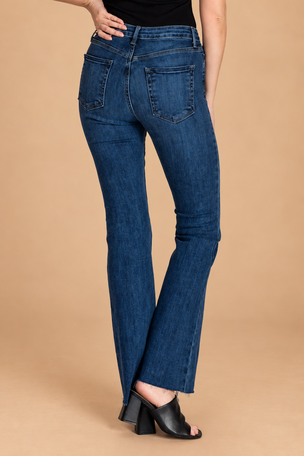 Scissor Cut Flare Jean — Dark Wash, back view on tan background