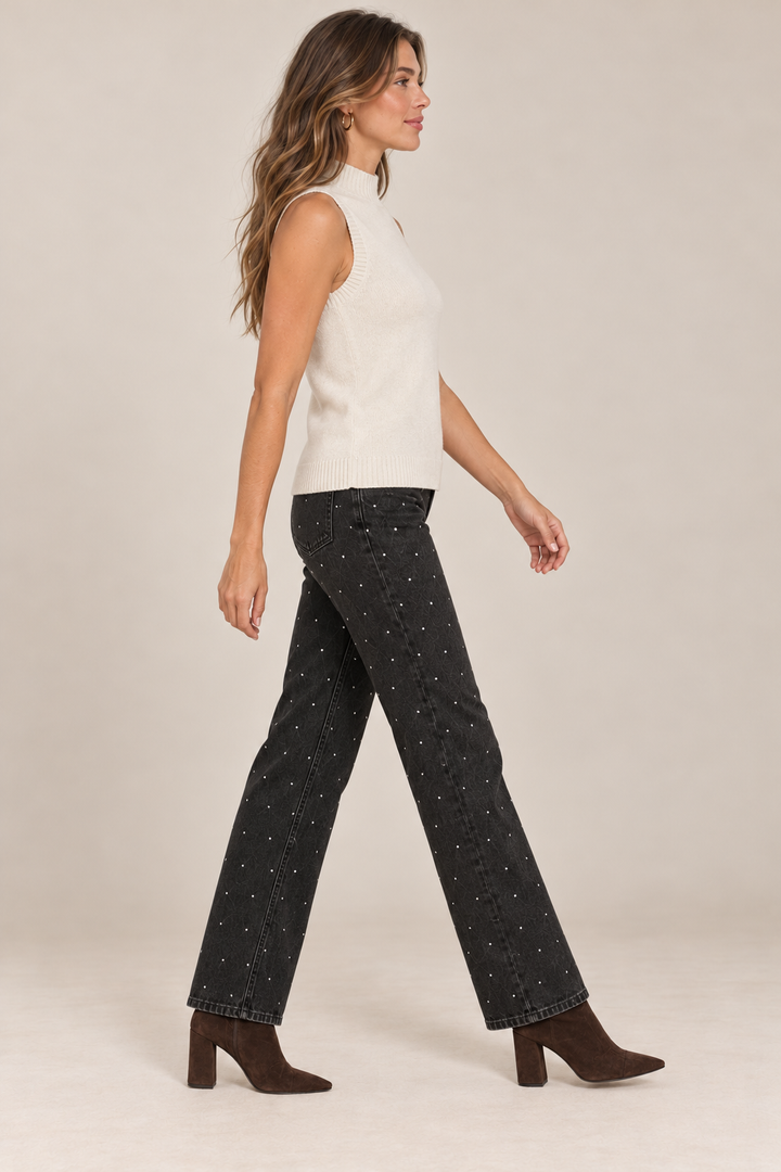 Sleeveless Knit Mock Neck Top in Beige — side view on holiday campaign model, rhinestone black jeans and chocolate boots, light tan studio.