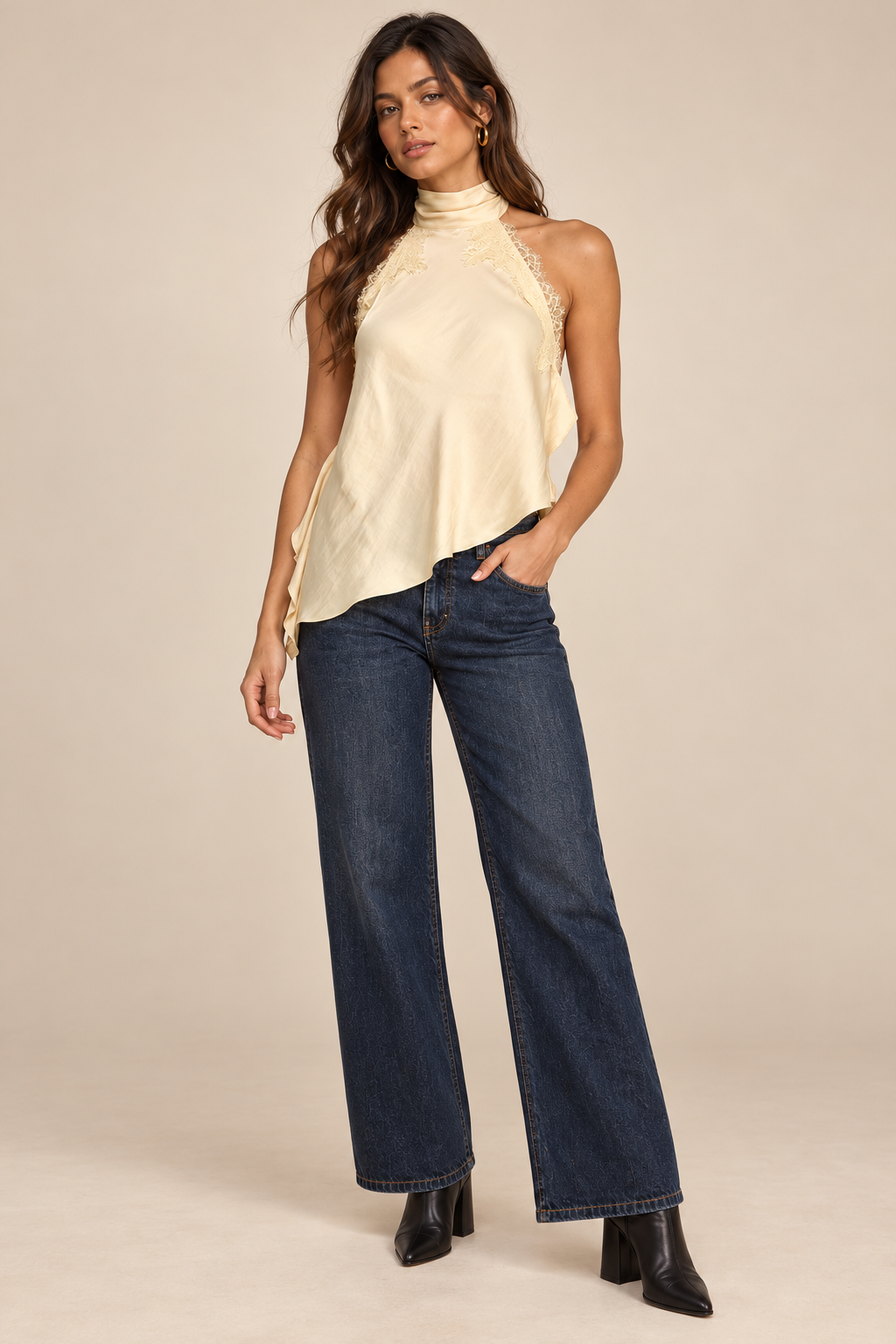 Nora Lace Trim Halter Top in Butter — front view on holiday campaign model, styled with dark jeans and black ankle boots on a light tan studio background.