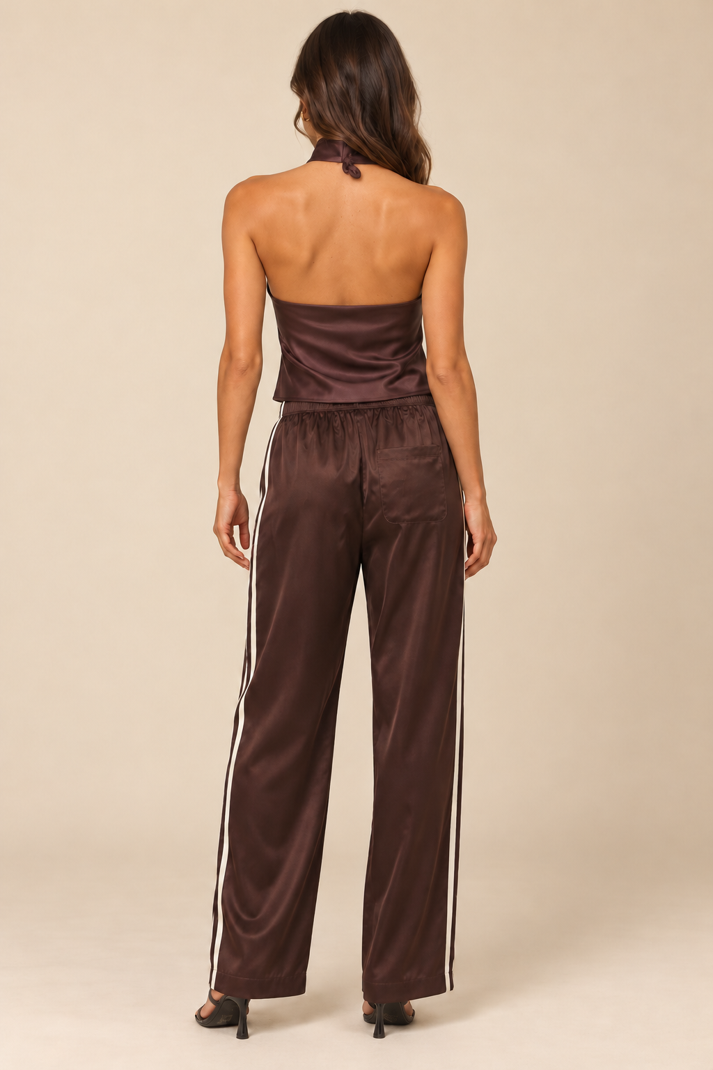 Side Stripe Silky Track Pant in Brown Natural — natural back view, styled with authentic open-back Romy satin halter, neck tie, one rear pocket and cream side stripes, light tan studio.