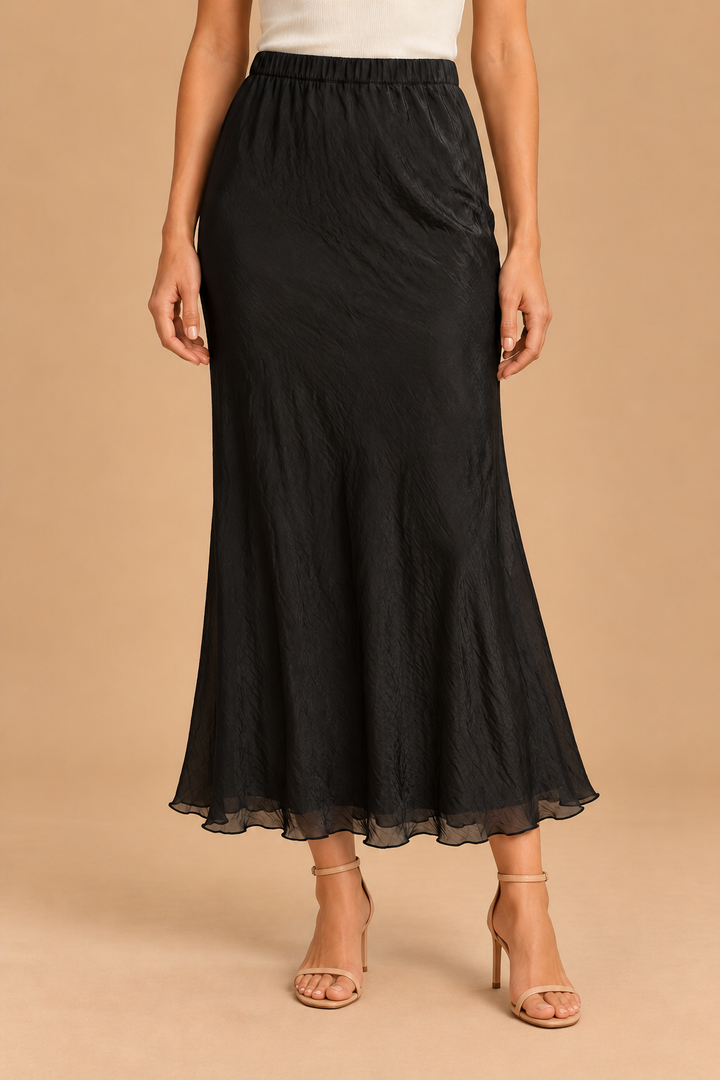 Maeve Silky Midi Skirt — Black, front view with heels