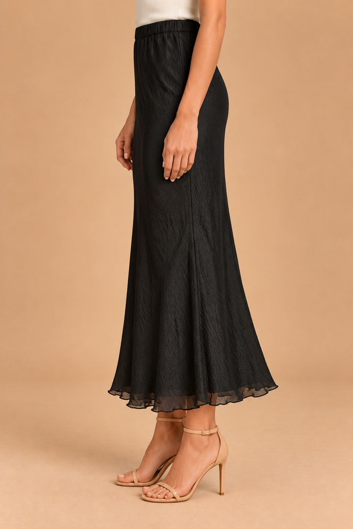 Maeve Silky Midi Skirt — Black, side view with heels