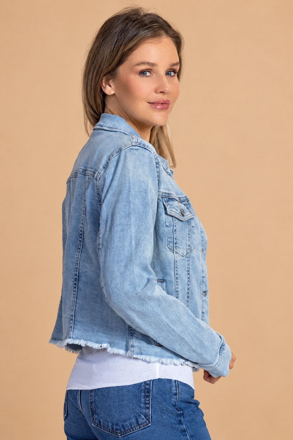 Distressed Jean Jacket — Denim, denim side view on tan background